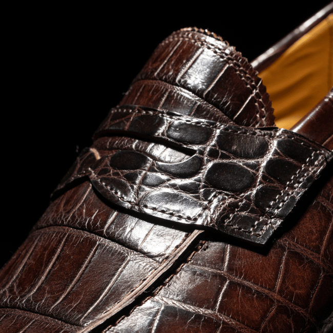 Men’s gray textured leather sneaker with tan rubber sole and brown leather lining