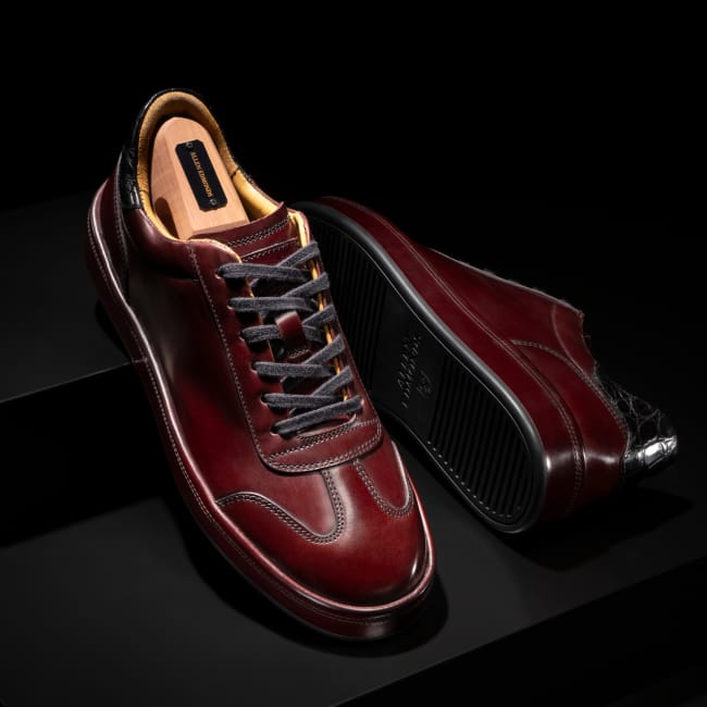 Bordeaux red leather Allen Edmonds Hawthorne Reserve sneaker with black laces and a branded cedar shoe tree 