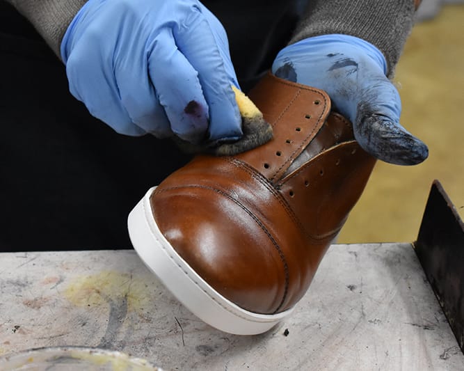 Polish applied to uppers for final refinishing
